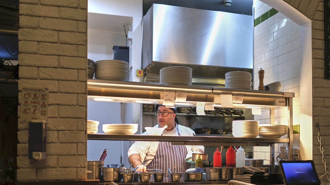A chef at work in a restaurant's open kitchen